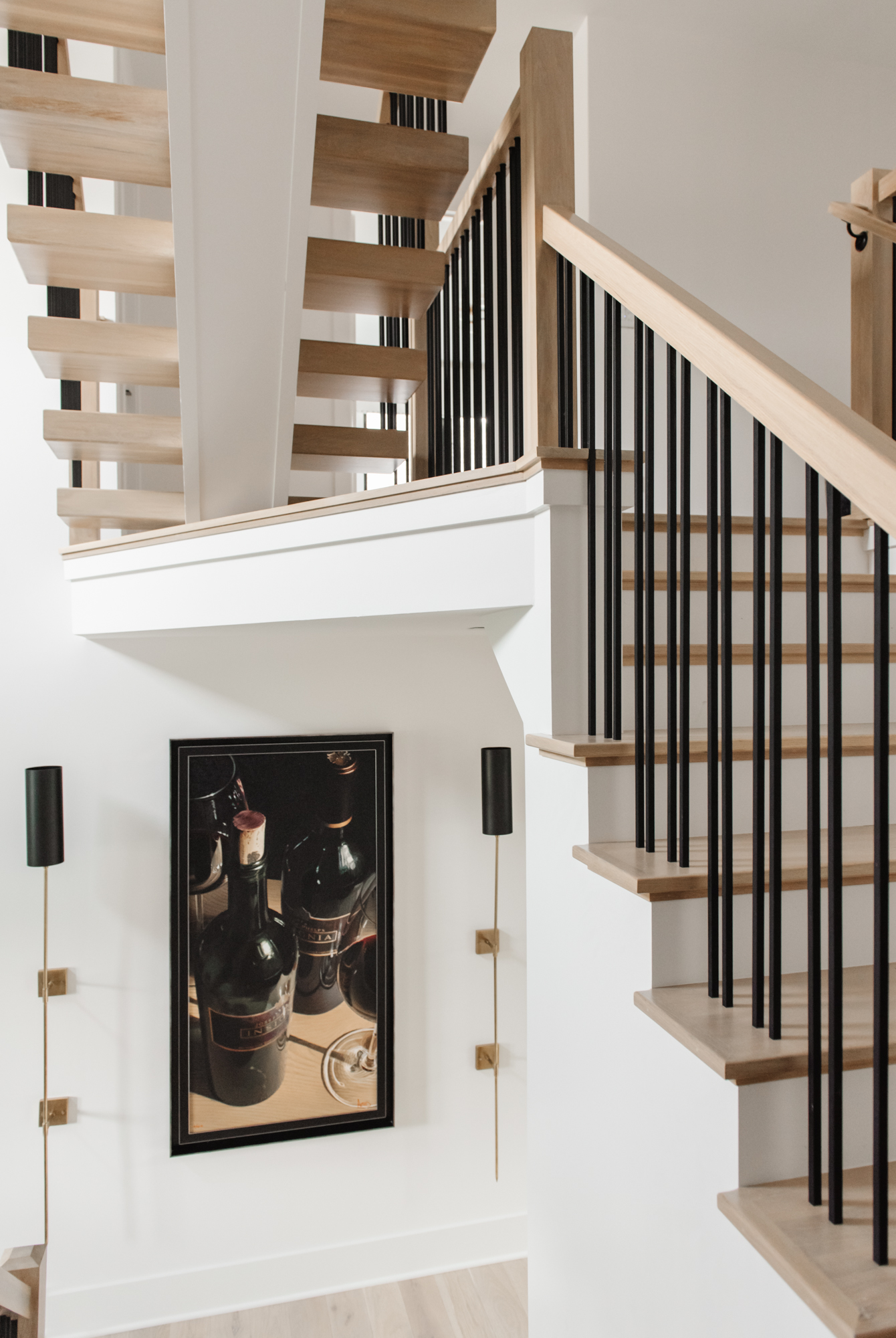 Modern floating stairs white white oak and iron balusters. Interior Design by LC Interiors, best interior designer in Naperville, Illinois.